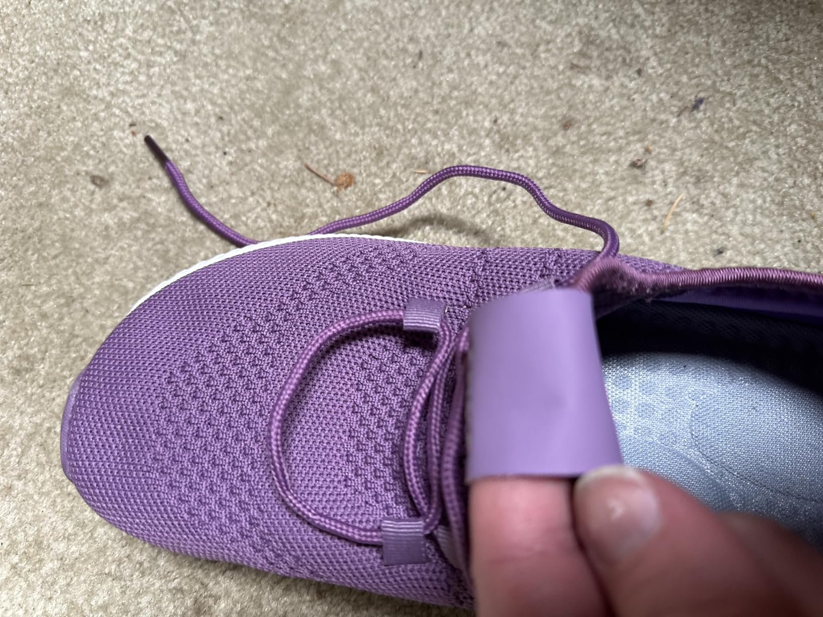 Detailed view of ZOVE's breathable mesh upper material and decorative lacing system