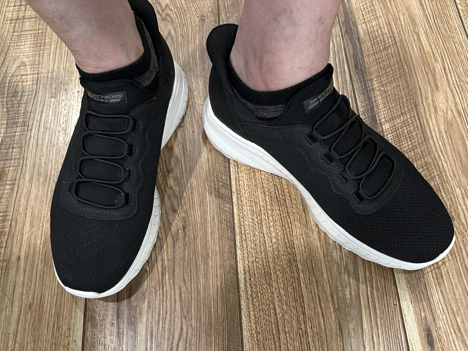 Skechers Men's Hands Free Slip-ins Bobs Squad black casual sneakers shown in everyday wear context